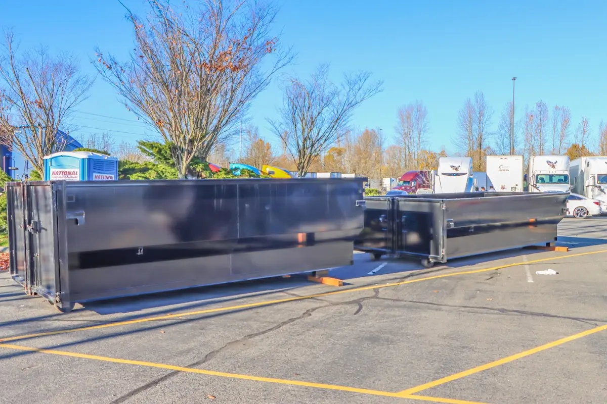 Professional dumpster rental service with roll-off container on residential driveway in Nacogdoches